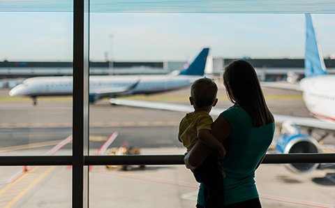 Woman and child looking at airplanes